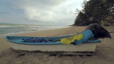 Small Boat on a Quiet Beach, Cloudy Day Stock Footage 66064369