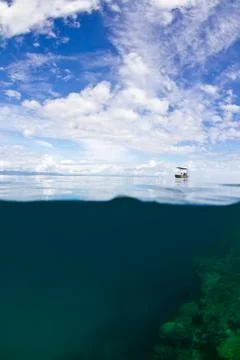 Small boat on the reef Stock Photos