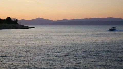 Small boat returning home on sunset Stock Footage 112824062