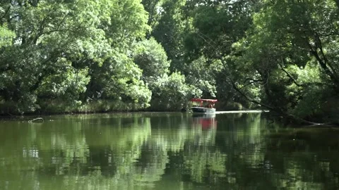 Small boat sailing across the river in Primorsko, Bulgaria Stock Footage 143963661