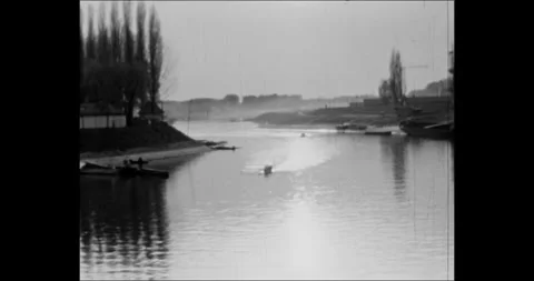 Small boat sailing on a calm river with reflections, vintage 8mm archival Stock Footage 341325723