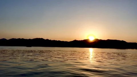 Small boat sailing on calm West Lake during a golden sunset in Hangzhou Video stock 342003041