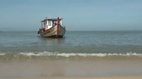 Small Boat Sailing Towards Beach Stock Footage
