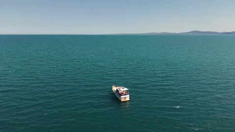 Small Boat Sailing in the Turquoise Bay of Pomorie, Black Sea, Bulgaria Stock Footage 343136588