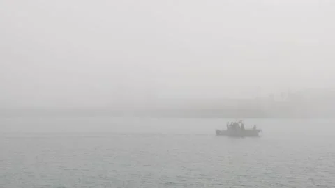 Small boat sailing under extreme foggy conditions Stock Footage 156906152