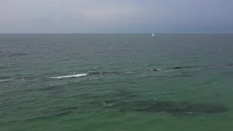 Small boat sails on the high seas in stormy weather Video stock 157705966