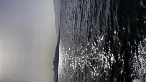 A small boat sails on the sea at sunset, a fishing boat sails in the ocean Stock Footage 238548770