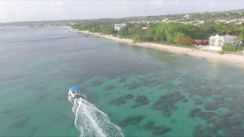 Small boat speeding on Caribbean beach Stock Footage 88572973