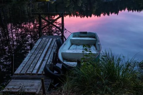 Small boat in sunset Stock Photos
