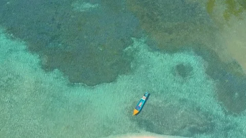 Small boat surrounded by endless azure w... | Stock Video | Pond5
