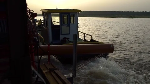 A small boat towing a large floating platform. Stock Footage 71167132