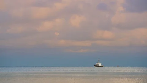 Small boat under evening clouds Stock Footage 83144960