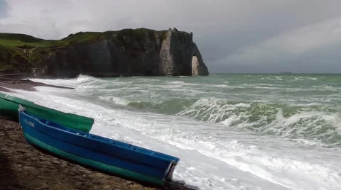 Small boats beach cliffs crashing waves stormy Stock Footage 60403434