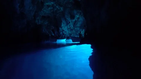 Small boats inside the Blue Cave on Bisevo Island, Croatia. Stunning Stock Footage 120608550