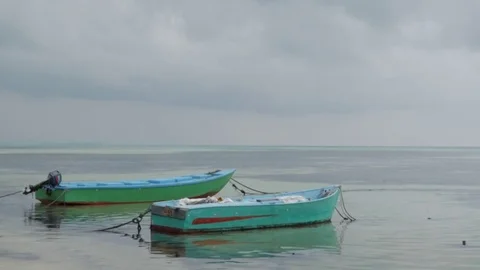 Small boats on the shore in cloudy day, Dhiffushi, Maldives Stock Footage 80022894