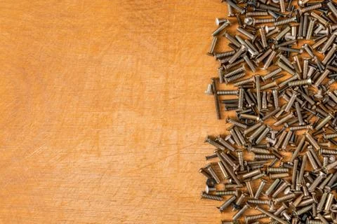 Small bolts on the table on the right. Stock Photos