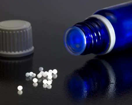 Small bottle and globules Stock Photos