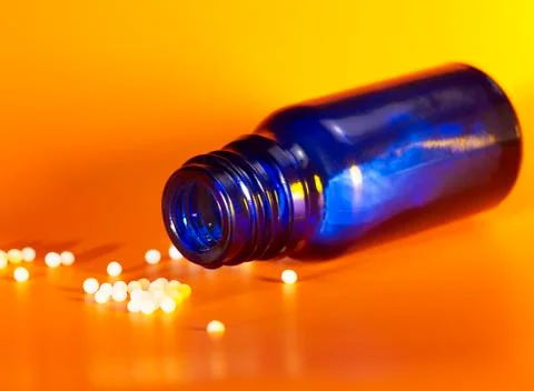 Small bottle and globules Stock Photos