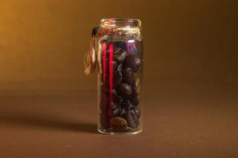 A small bottle with coffee beans on a brown background Stock Photos