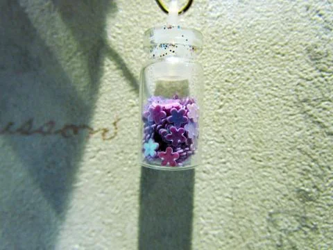 Small bottle with a decorative material for nail design Stock Photos