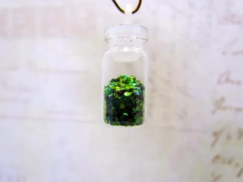 Small bottle with a decorative material for nail design Stock Photos