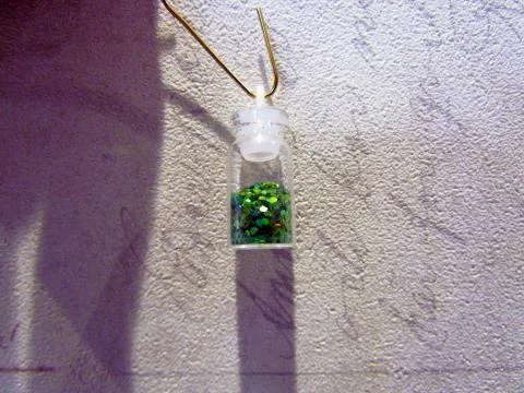 Small bottle with a decorative material for nail design Stock Photos