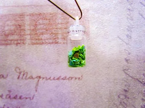 Small bottle with a decorative material for nail design Stock Photos