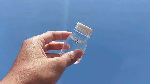 A small bottle with a white lid containing mineral water or Zam Zam water Stock Footage 278204953