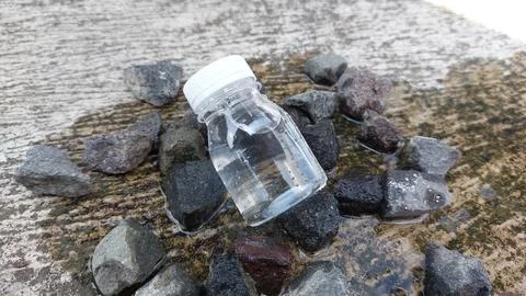 A small bottle with a white lid containing mineral water or Zam Zam water Stock Photos