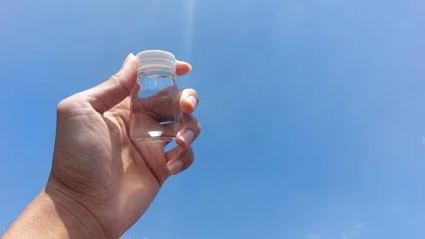 A small bottle with a white lid containing mineral water or Zam Zam water Stock Photos