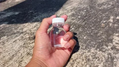 A small bottle with a white lid containing mineral water or Zam Zam water Stock Photos