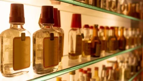 Small bottles of grappa on the shelf Stock Photos