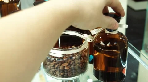Small bottles with perfume and coffee on a show-window 스톡 동영상 57853555