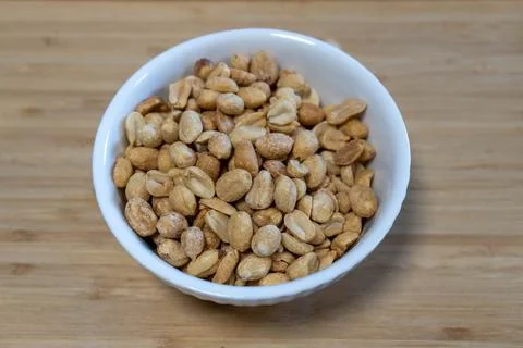 A small bowl filled with peanuts, emphasizing simplicity and natural snacking Stock Photos