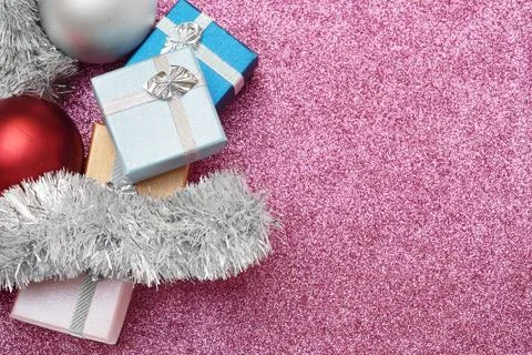 Small boxes for gift, balls and christmas tinsel on red Stock Photos