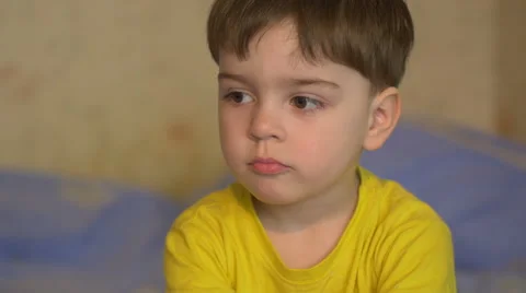 Small boy 3 years looking into the camera depicting various emotions Видео 61711837