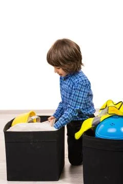 Small boy arrange things in boxes Stock Photos