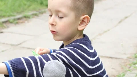 Small boy blowing bubbles. Happy child blowing soap bubbles in spring park. Stock Footage 107251041