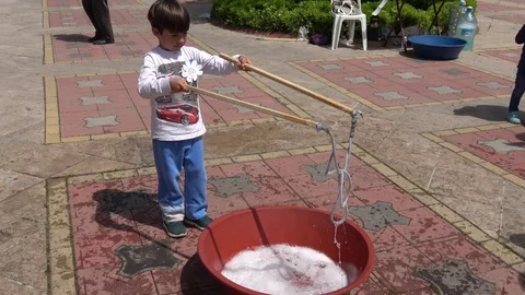 Small boy blows the longest string of soap bubbles Video stock 107263844