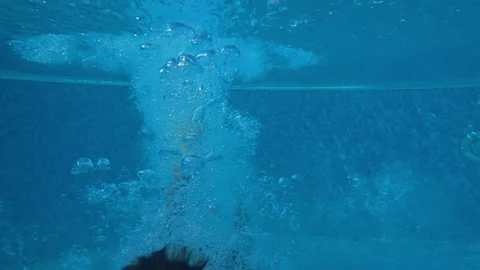 Small boy diving in the pool and looking at the camera Stock Footage 155139736