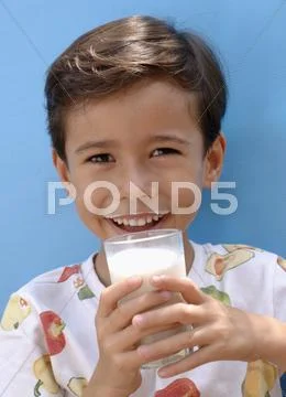 Small Boy Drinking A Glass Of Milk