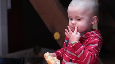 Small boy eating a donut. Видео 20625357