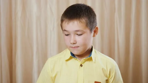 Small boy feels guilty and shame, he is sad, keeping silence. Portrait of child Stock Footage 141685940