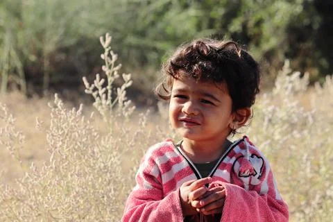 A small boy of Indian origin looking at the camera with small eyes Foto stock