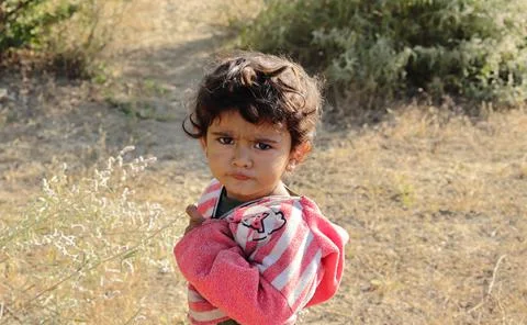 A small boy of Indian origin looking at the camera angrily Stock Photos