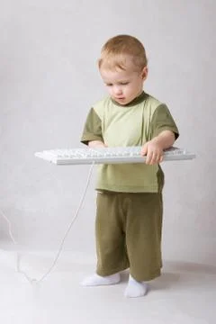 Small boy with a keyboard in hands Stock Photos