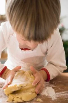 Small boy kneading dough Stock Photos