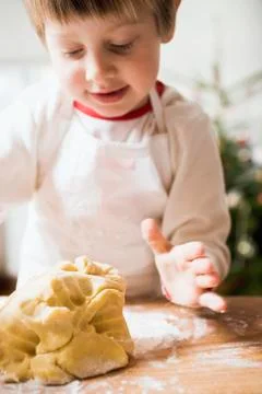 Small boy kneading dough Stock Photos