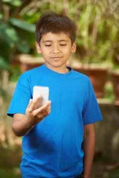 Small boy look into smartphone Stock Photos