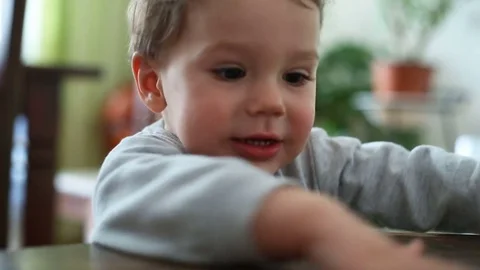Small boy looks happy while taking colorful blocks Stock Footage 75150599